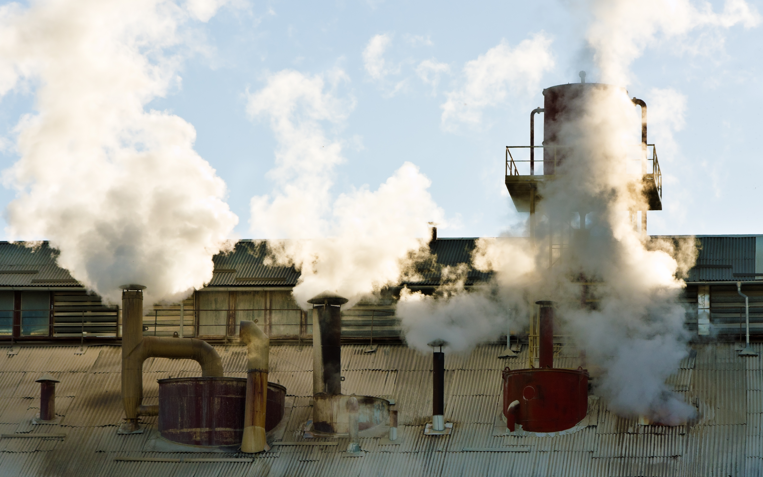 Steam emanating from industrial facility with steam distribution system maintained, tested & repaired by APM Steam